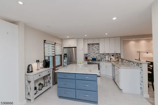 a kitchen with sink a stove and refrigerator