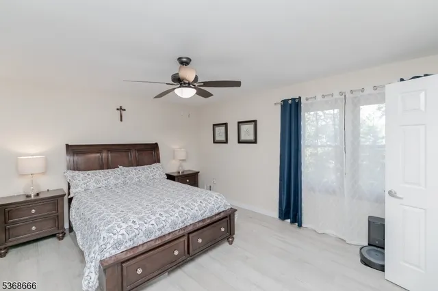 a bedroom with a large bed and a chandelier