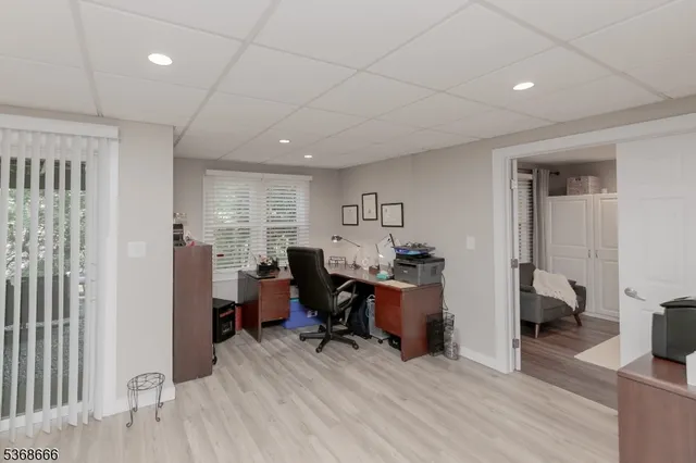 a view of a workspace with furniture and a bedroom