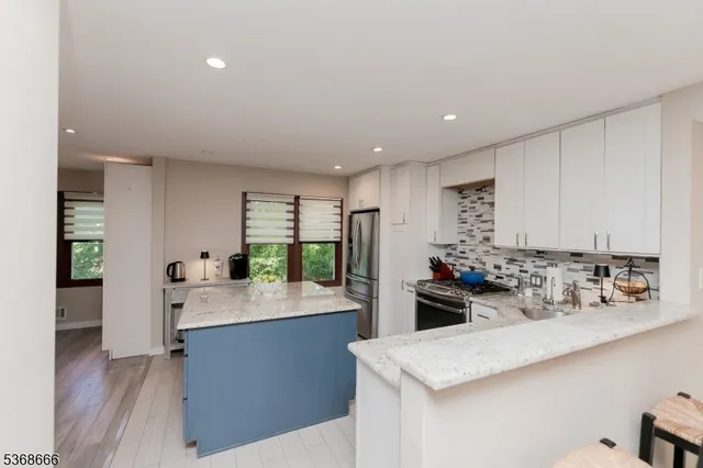 a kitchen with a sink stove and refrigerator