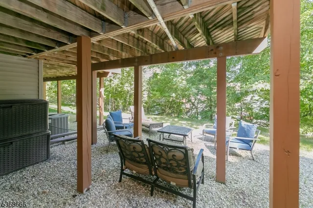 a view of a porch with chairs and backyard