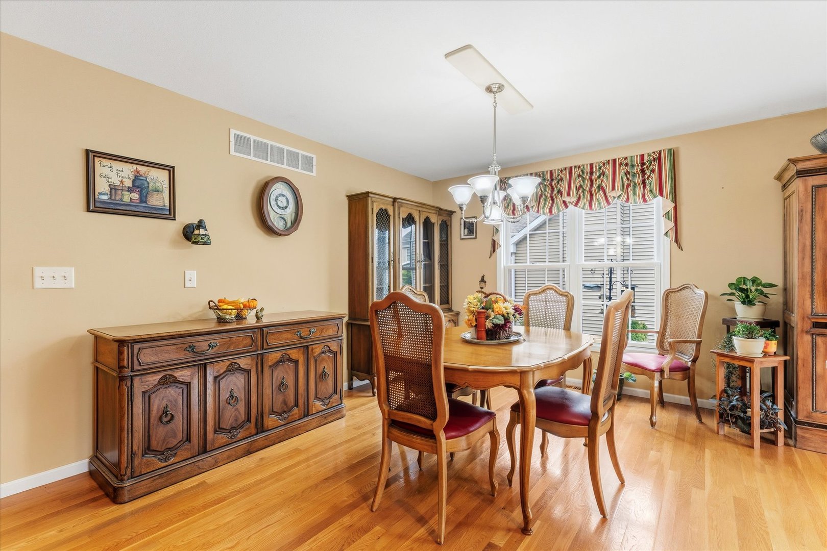 1706 Tin Cup Road, Unit 1706 Mahomet, IL 61853 - Photo 12 of 43 a view of a dining room with furniture window and wooden floor