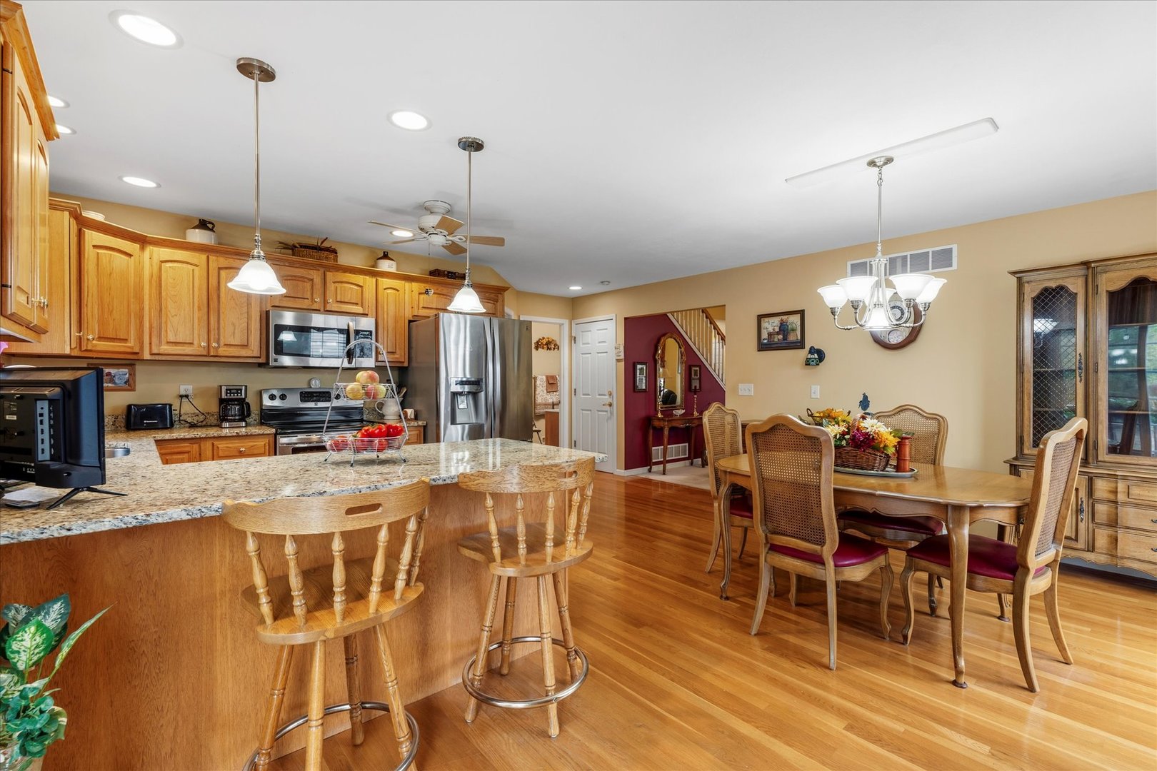 1706 Tin Cup Road, Unit 1706 Mahomet, IL 61853 - Photo 13 of 43 a view of a dining room with furniture window and wooden floor