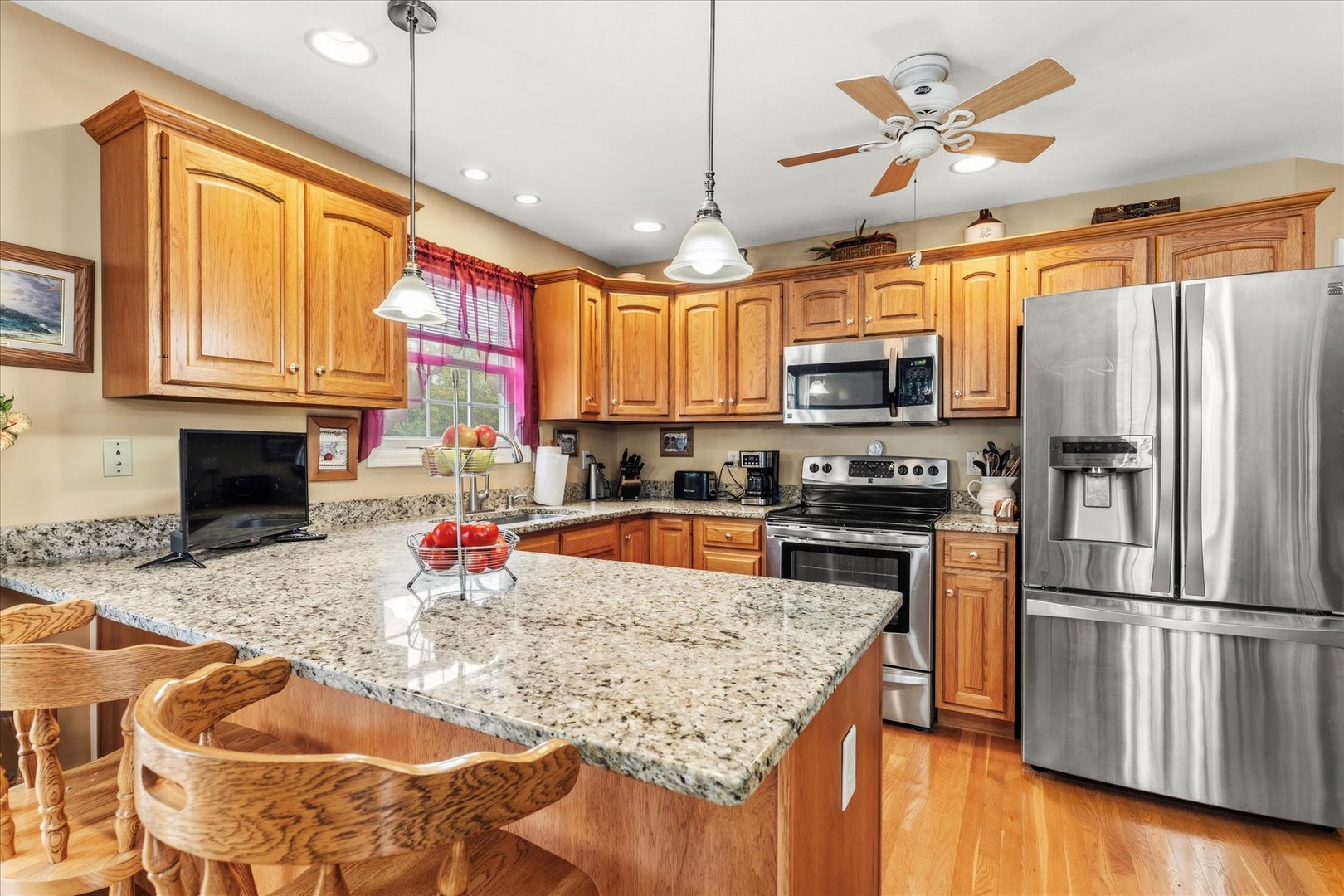 1706 Tin Cup Road, Unit 1706 Mahomet, IL 61853 - Photo 15 of 43 a kitchen with stainless steel appliances granite countertop a sink a stove and a wooden floors