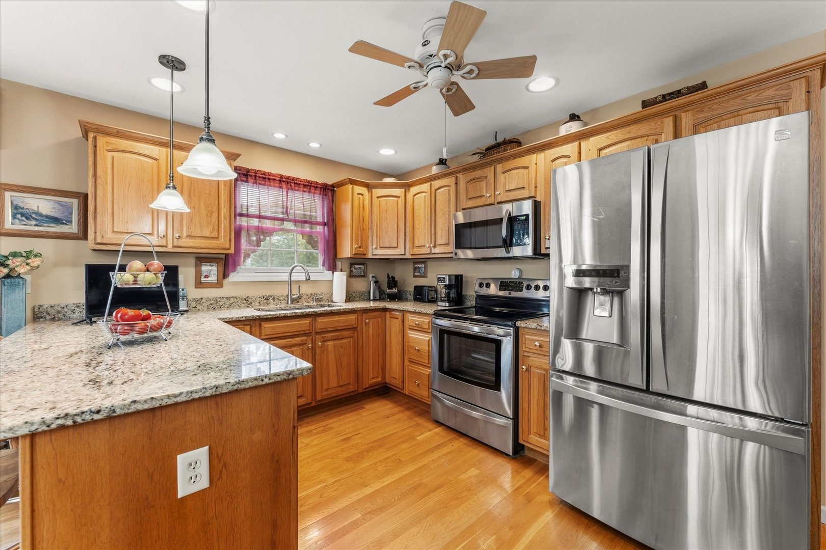 1706 Tin Cup Road, Unit 1706 Mahomet, IL 61853 - Photo 16 of 43 a kitchen with stainless steel appliances granite countertop a refrigerator a stove a sink and a microwave