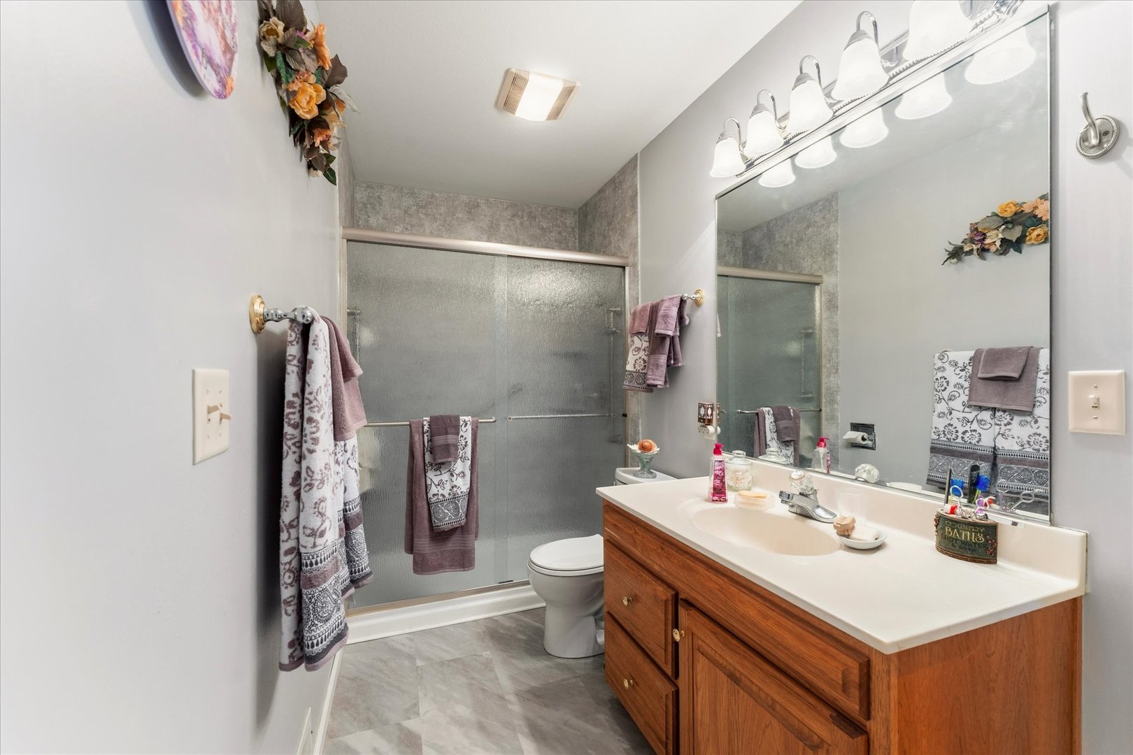 1706 Tin Cup Road, Unit 1706 Mahomet, IL 61853 - Photo 24 of 43 a bathroom with a sink toilet and shower