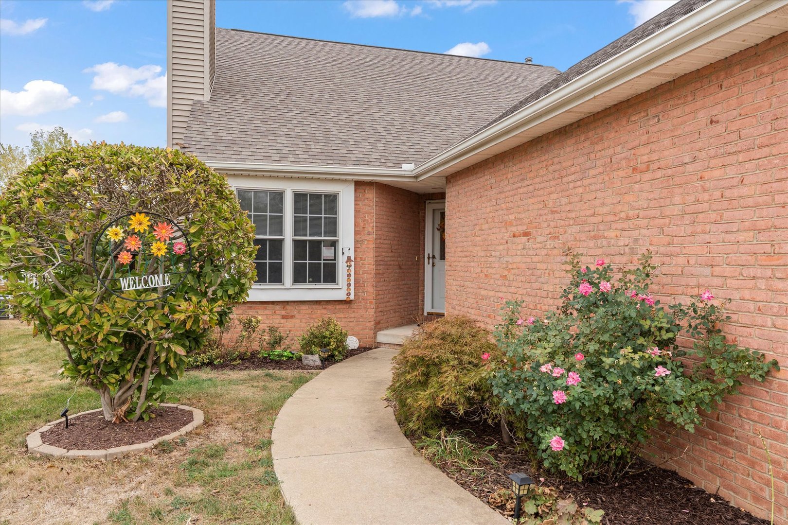 1706 Tin Cup Road, Unit 1706 Mahomet, IL 61853 - Photo 3 of 43 a front view of a house with a yard