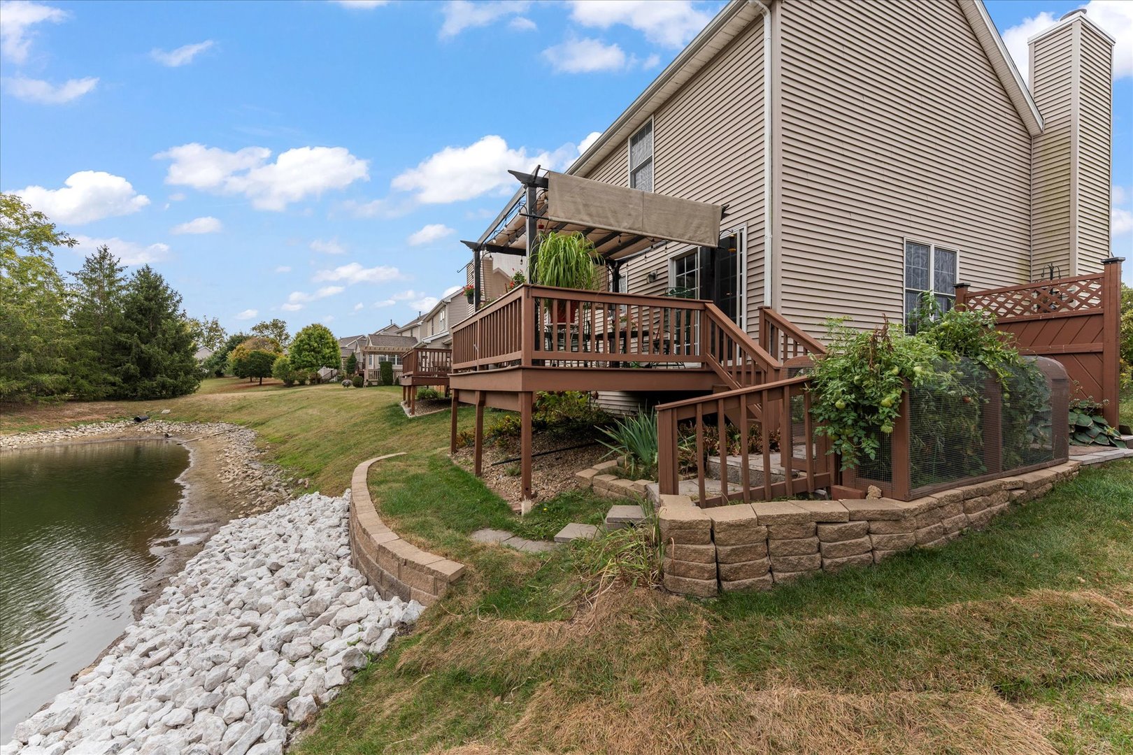 1706 Tin Cup Road, Unit 1706 Mahomet, IL 61853 - Photo 38 of 43 a house view with a garden space