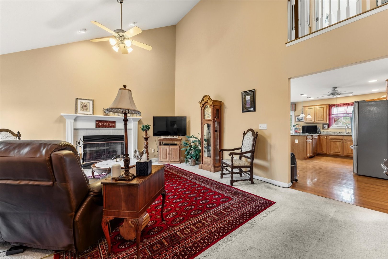 1706 Tin Cup Road, Unit 1706 Mahomet, IL 61853 - Photo 7 of 43 a living room with furniture a flat screen tv and kitchen view