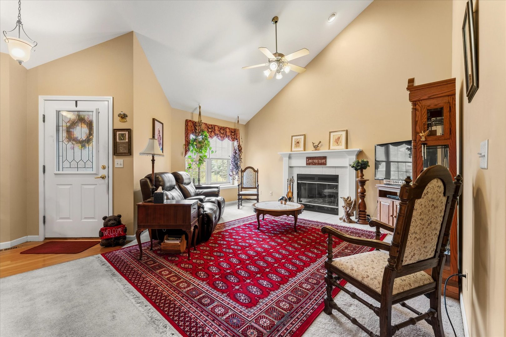 1706 Tin Cup Road, Unit 1706 Mahomet, IL 61853 - Photo 8 of 43 a living room with furniture a flat screen tv and a fireplace