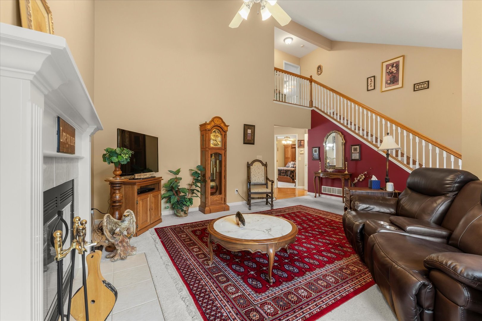 1706 Tin Cup Road, Unit 1706 Mahomet, IL 61853 - Photo 10 of 43 a living room with furniture a flat screen tv and a fireplace