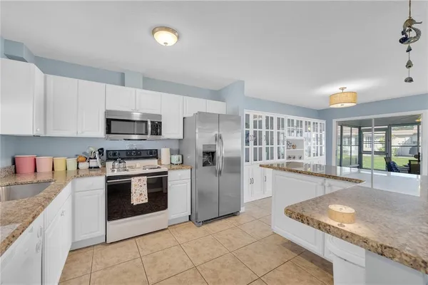a kitchen with stainless steel appliances granite countertop a stove and a sink