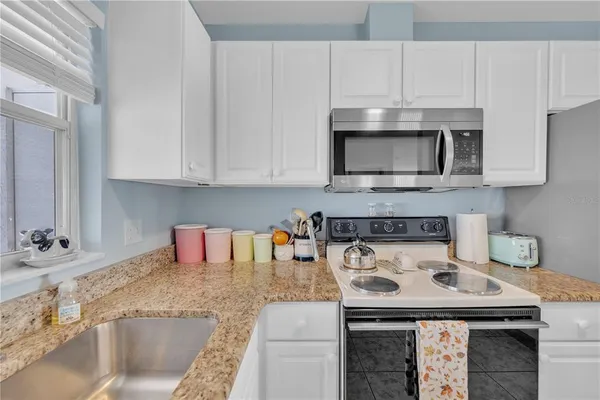 a kitchen with a stove and a microwave