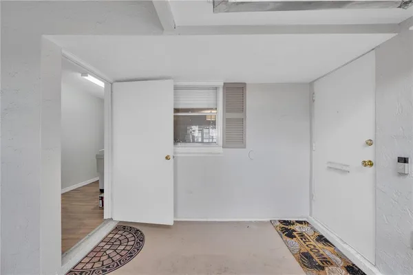 a view of room with window and a ceiling fan