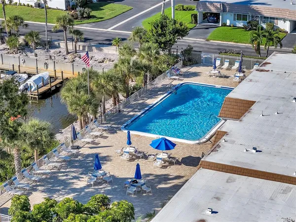 an aerial view of a house with yard swimming pool and outdoor seating