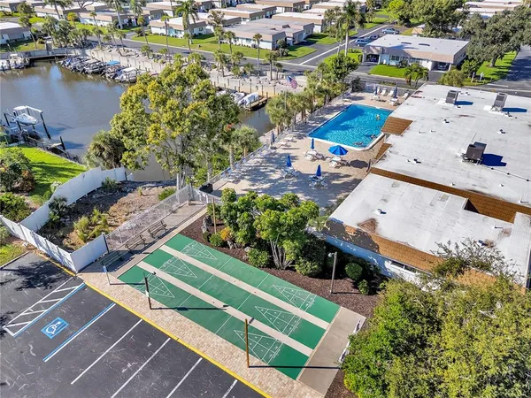 an aerial view of a house with a garden and lake view