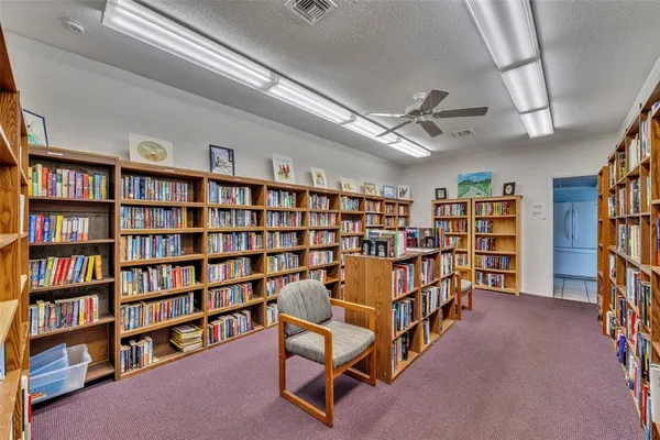 a living room with a book shelf and a book shelf
