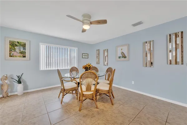 a dining room with furniture and window