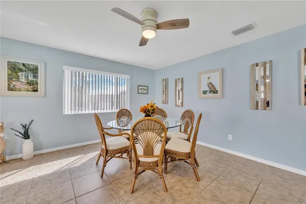 a view of a dining room with furniture and a potted plant