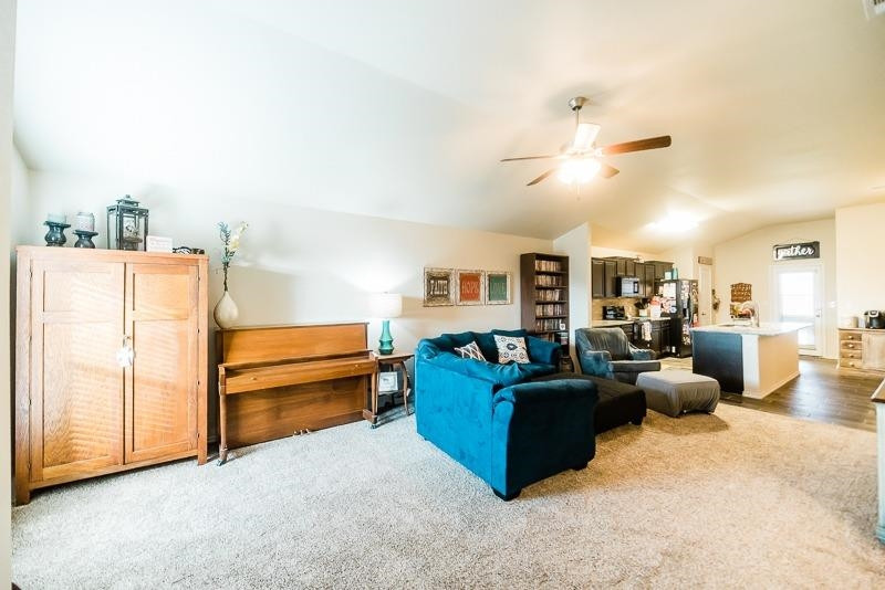 7426 103rd Street Lubbock, TX 79424 - Photo 3 of 10 a living room with furniture and a chandelier