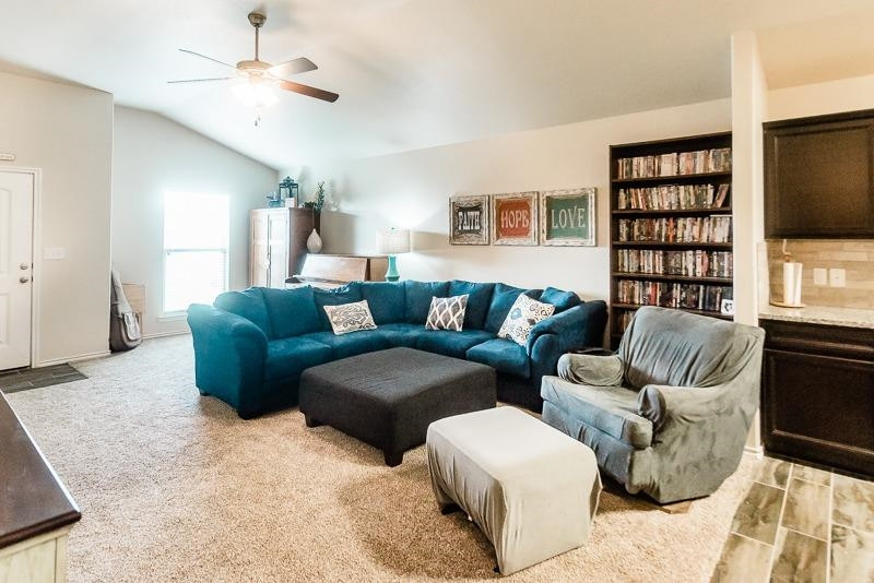 7426 103rd Street Lubbock, TX 79424 - Photo 4 of 10 a living room with furniture ceiling fan and a flat screen tv