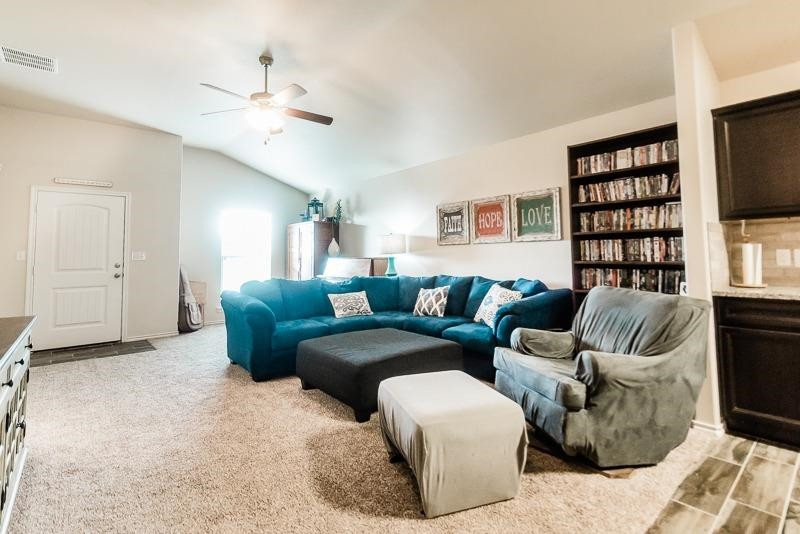 7426 103rd Street Lubbock, TX 79424 - Photo 5 of 10 a living room with furniture and a flat screen tv
