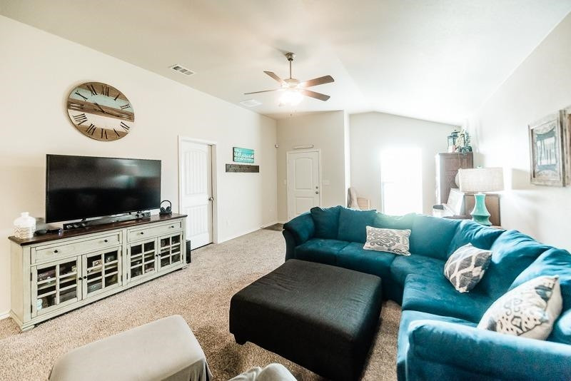 7426 103rd Street Lubbock, TX 79424 - Photo 6 of 10 a living room with furniture and a flat screen tv