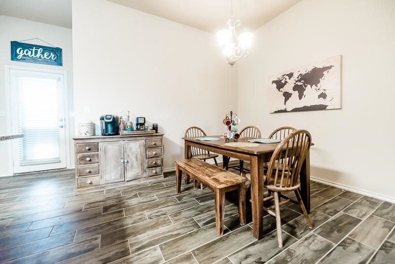 7426 103rd Street Lubbock, TX 79424 - Photo 10 of 10 a view of a dining room with furniture and wooden floor