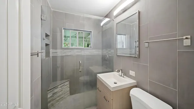 a bathroom with a sink toilet and shower