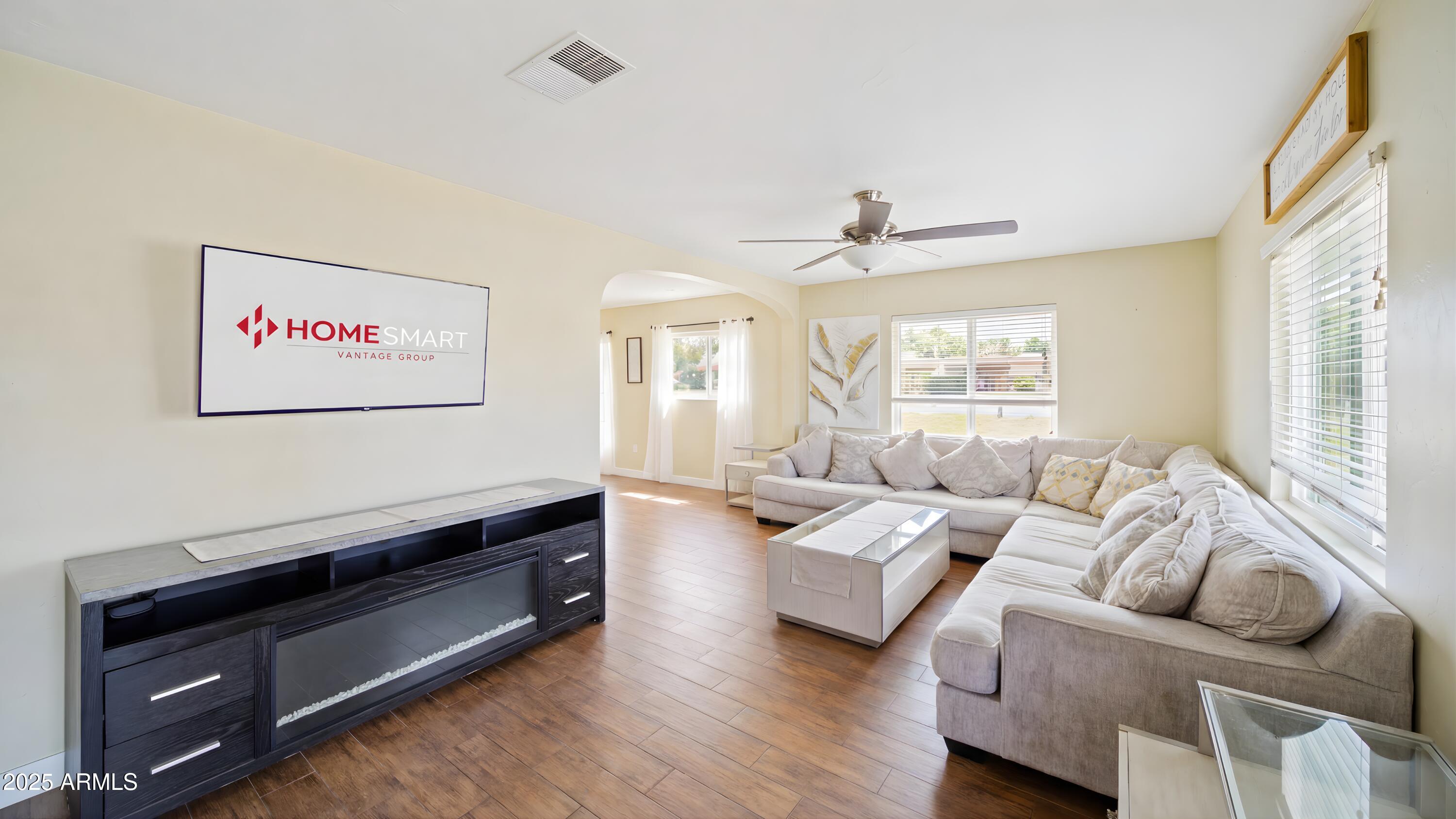 945 East Missouri Avenue Phoenix, AZ 85014 - Photo 3 of 15 a living room with furniture a large window and a chandelier