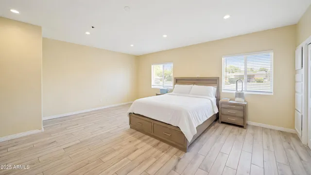 a bedroom with a bed and wooden floor