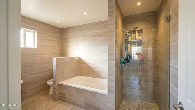a bathroom with a bathtub and a shower