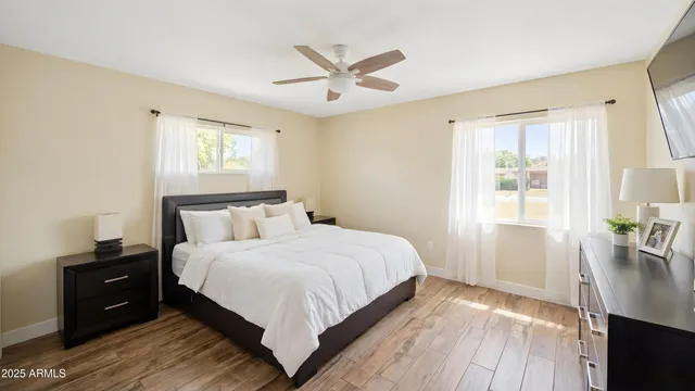 a bedroom with a bed and wooden floor