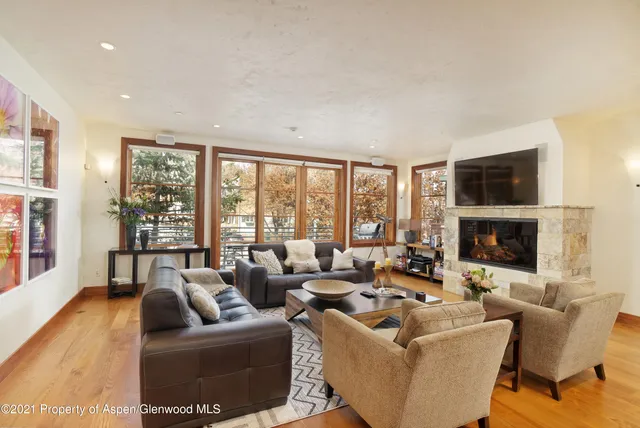 a living room with fireplace furniture and a flat screen tv
