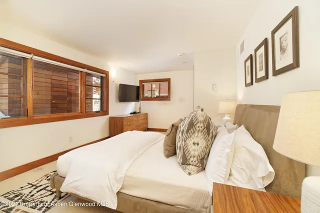 a bedroom with a bed and a large window