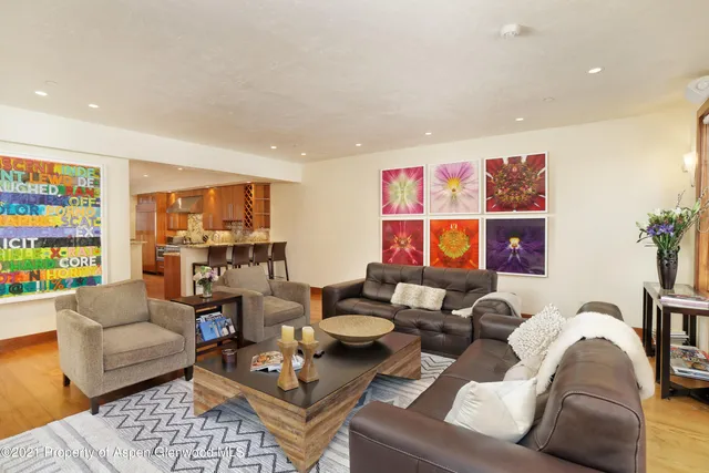 a living room with furniture kitchen and a table