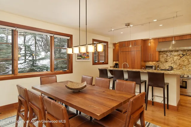 a dining room with furniture a window and appliances