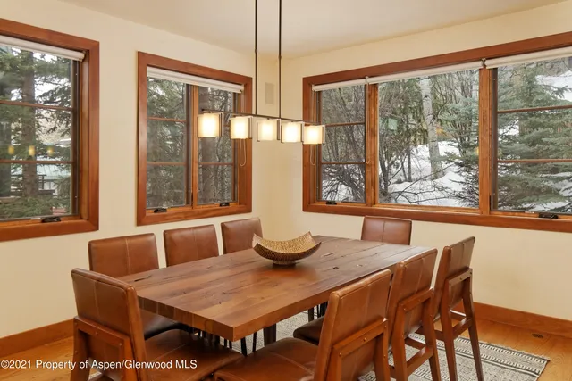a dining room with furniture wooden floor and a chandelier