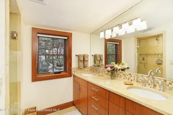 a bathroom with a double vanity sink and a mirror