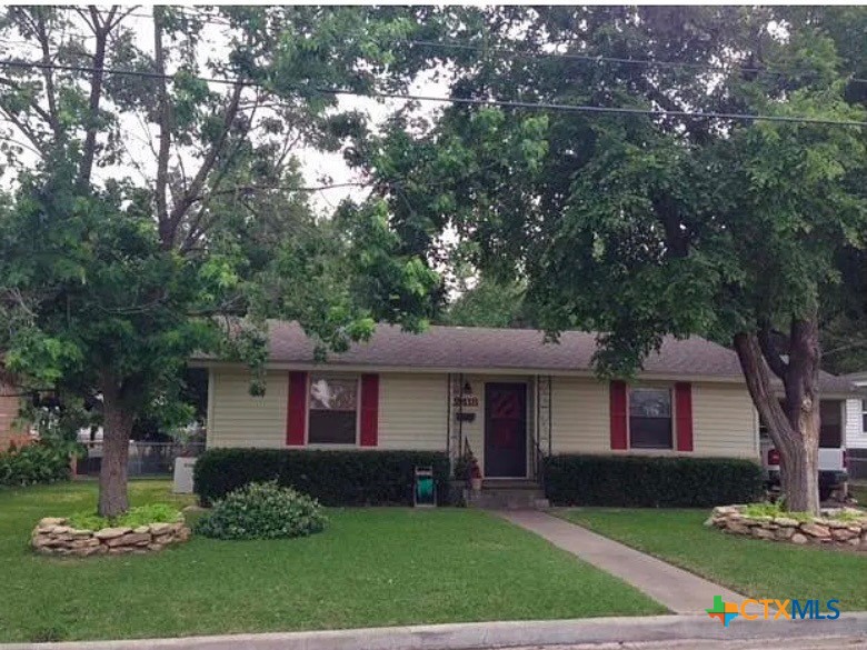 2418 Osage Road Gatesville, TX 76528 - Photo 1 of 15 a front view of a house with a yard and trees