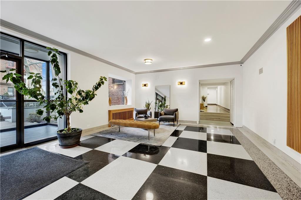 9902 3rd Avenue, Unit 1M Brooklyn, NY 11209 - Photo 18 of 20 a room with furniture and a potted plant