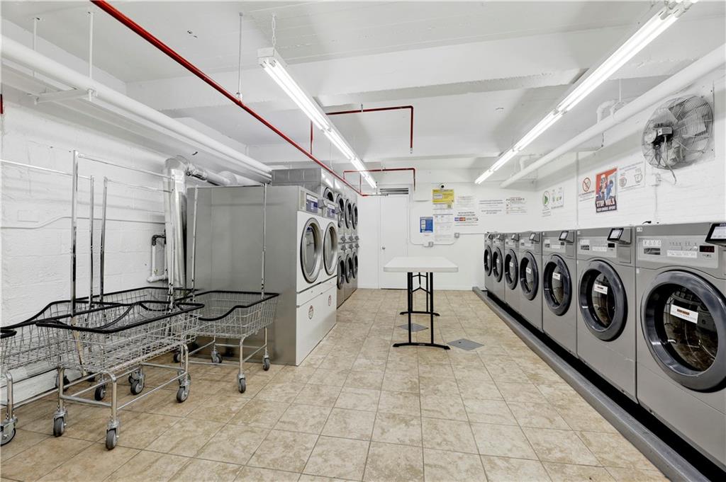 9902 3rd Avenue, Unit 1M Brooklyn, NY 11209 - Photo 19 of 20 a view of a storage utility room with washer and dryer