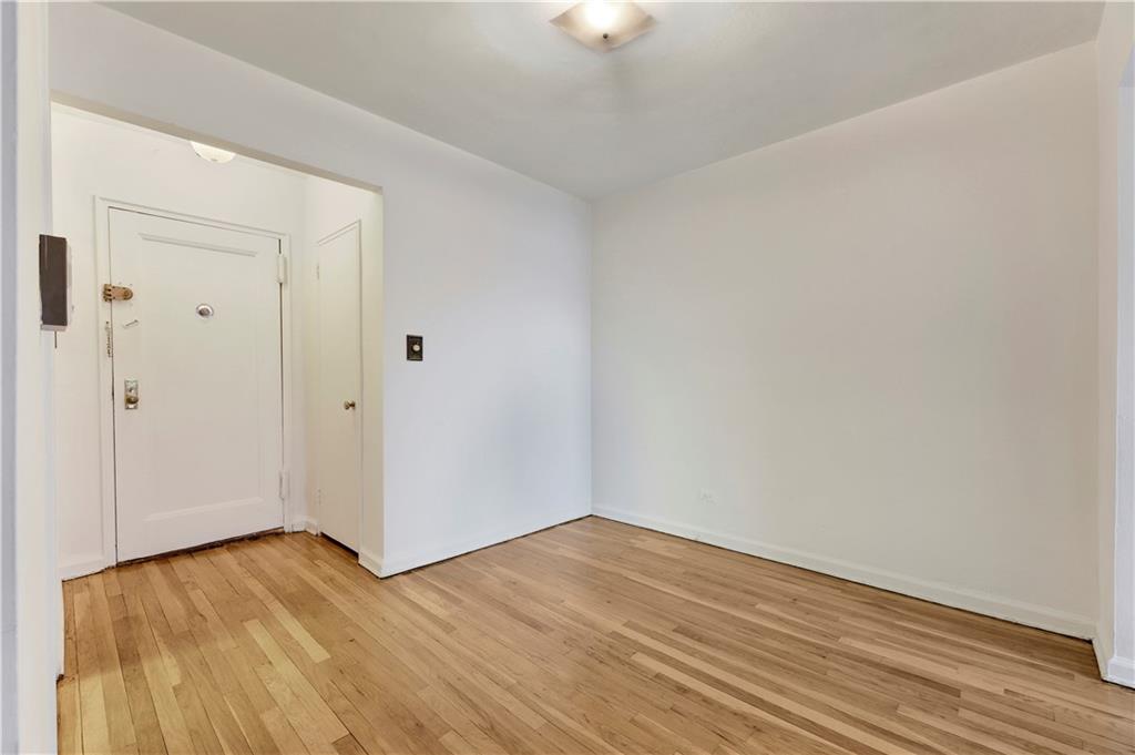 9902 3rd Avenue, Unit 1M Brooklyn, NY 11209 - Photo 7 of 20 wooden floor in an empty room