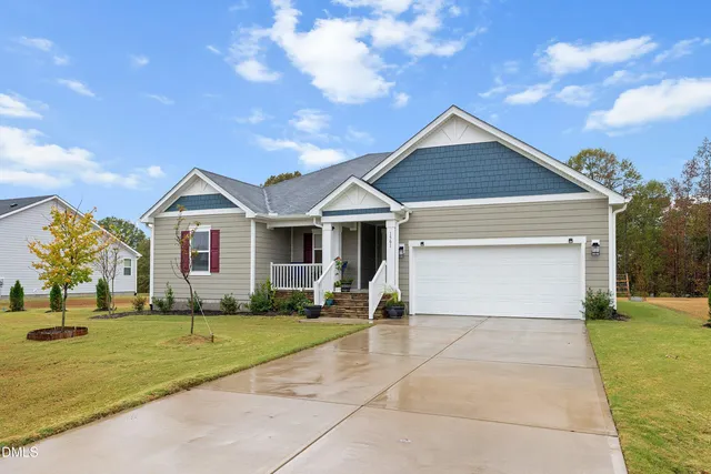a front view of house with yard and green space