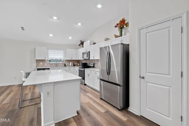 a kitchen with a refrigerator and a sink