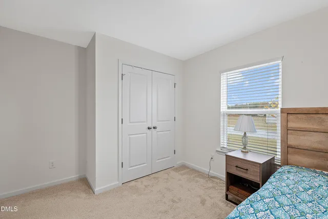 a room with a bed and a window