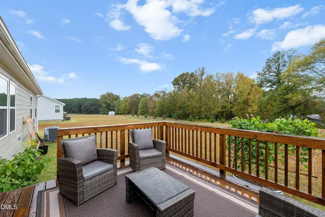 a view of a roof deck with couches and city view