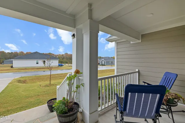 a view of a balcony with chairs