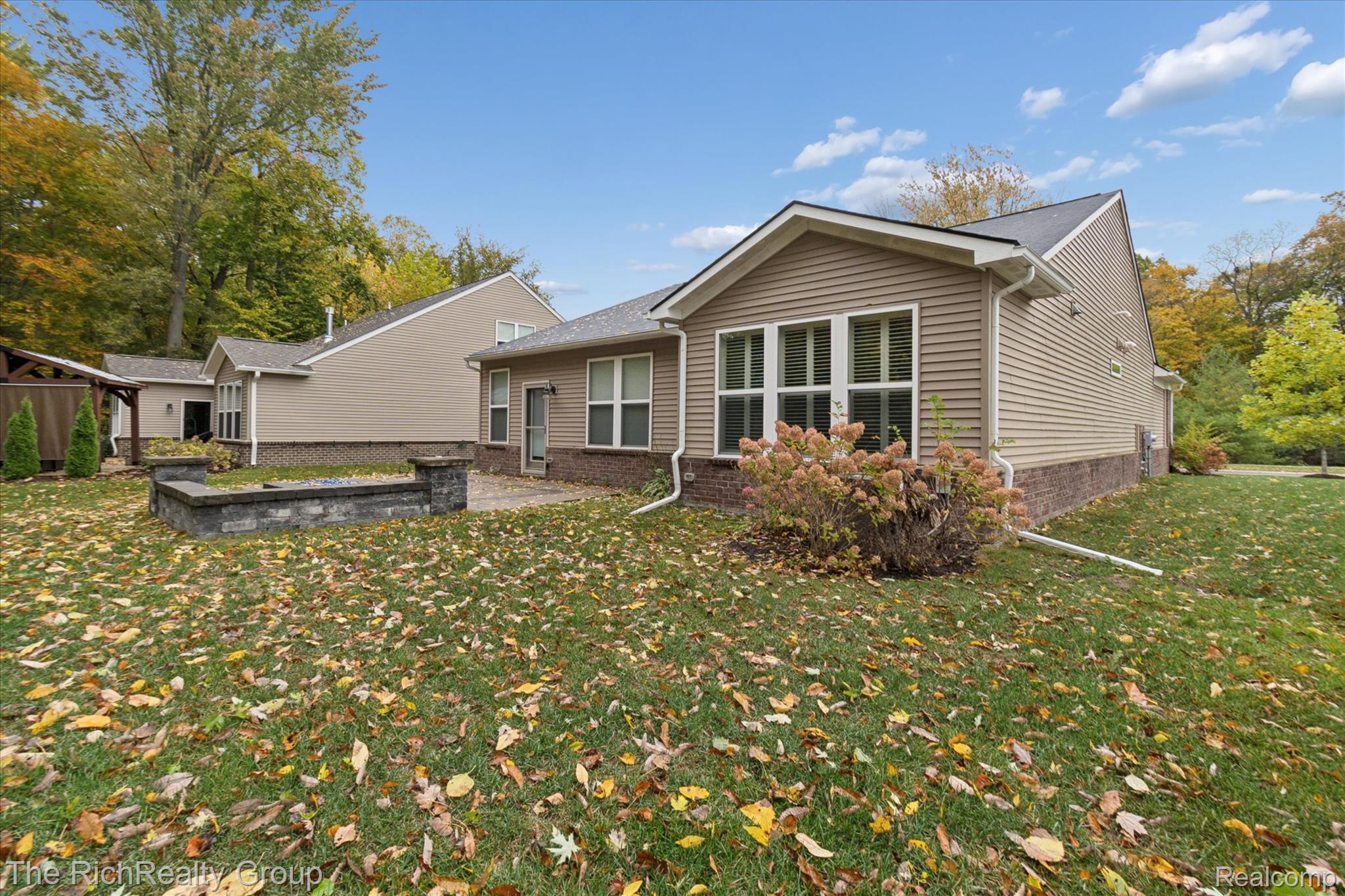49534 Mapleton Road Canton, MI 48188 - Photo 36 of 37 Back of property with a lawn and a patio area