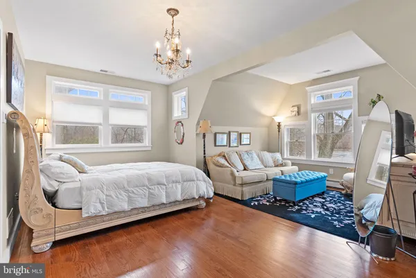 a bedroom with bed and wooden floor